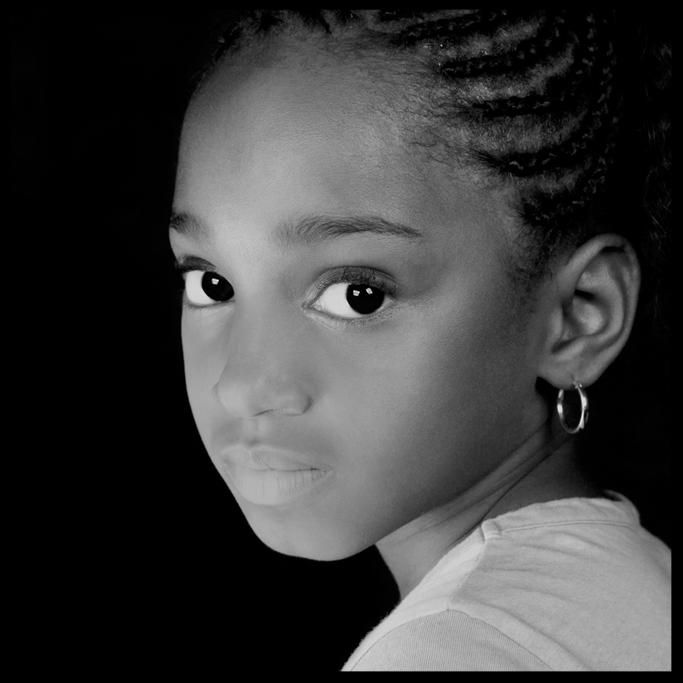 a small Black child looking into the camera.
