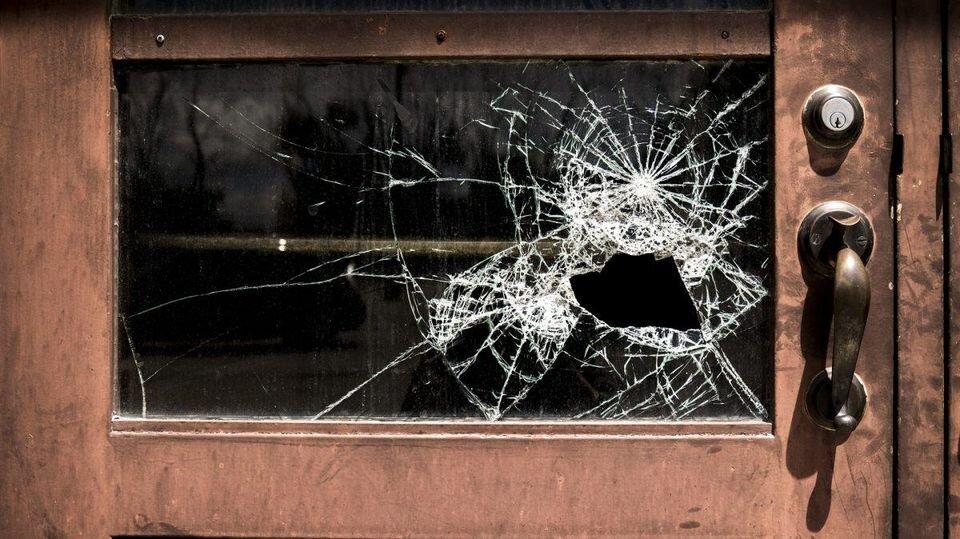 A door with a smashed glass window.